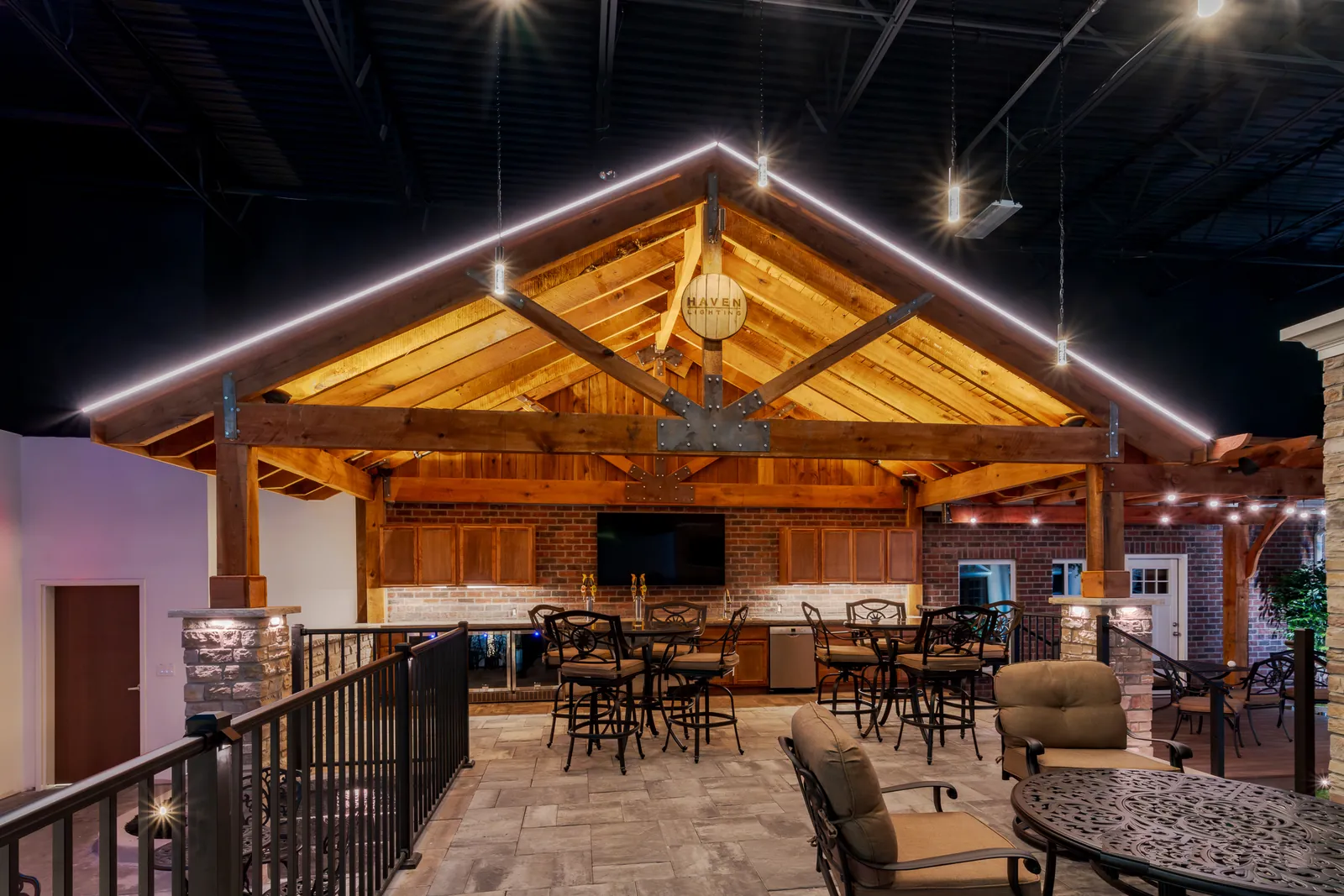Covered patio with warm white permanent lighting along the gable